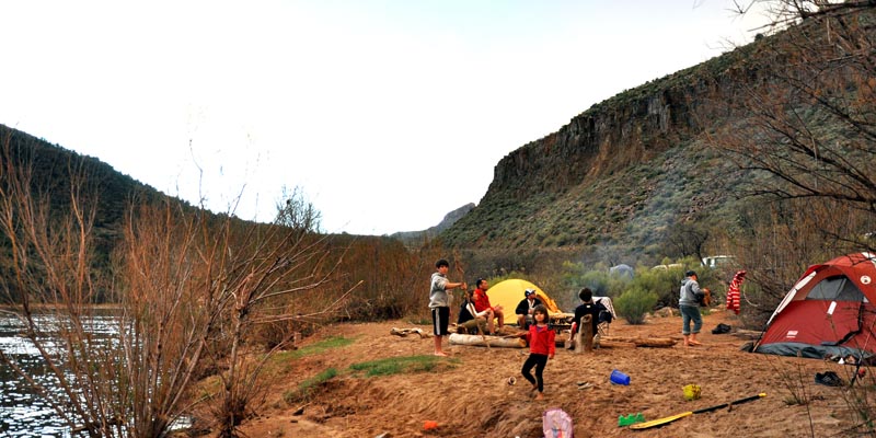 family camping along the river