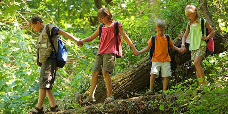 kids hiking along the river